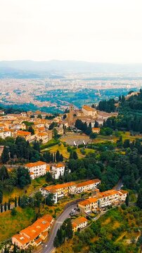 Vertical video. Florence, Italy. Fiesole is a city in the Tuscany region, in the province of Florence. The city of Florence in the background of the panorama. Drone footage, Point of interest. Rich c