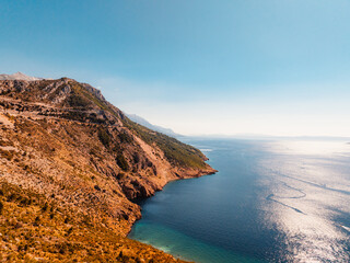 Obraz premium Aerial panoramic view of Makarska Riviera with turquoise Adriatic sea and Biokovo mountain range in the background, Dalmatia, Croatia.