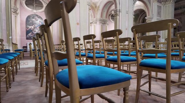 Rows Of Wooden Pews In Catholic Church Interior