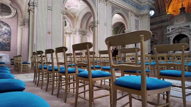 Rows Of Wooden Pews In Catholic Church Interior