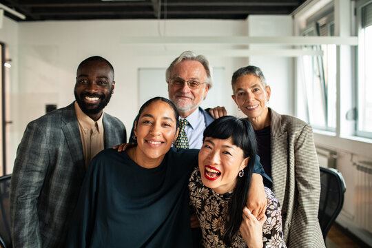 Diverse coworkers smiling together in modern office