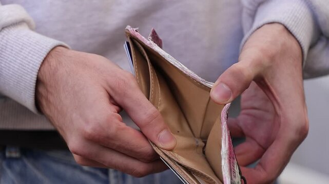 young hand opening empty wallet
