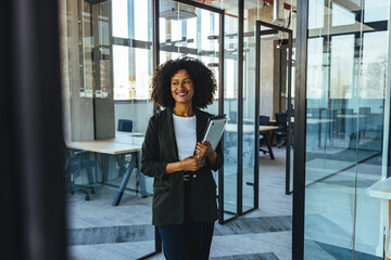 Professional Business Woman Walking Through Modern Glass Office Holding Tablet and Smiling