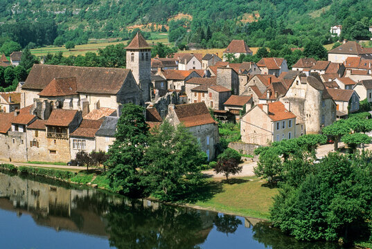 View of Marcilhac-sur-Cele alongside the Cele River in the Lot department of Midi-Pyrenees region during a sunny day