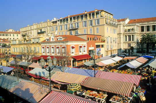 Colorful market stands filled with fresh produce and goods in old town Nice, France at Cours Saleya