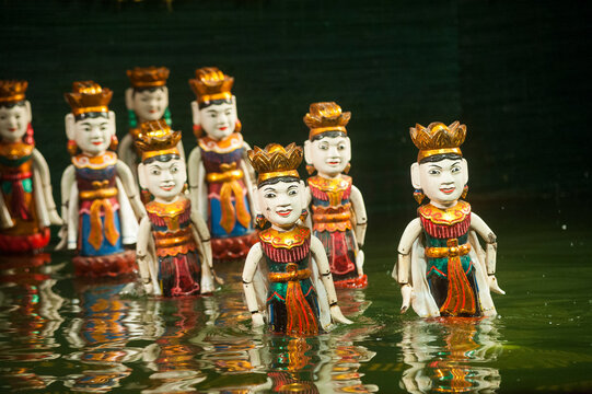 Water puppets perform at Thang Long Water Puppet Theatre in Hanoi, Vietnam, showcasing traditional art in a vibrant setting