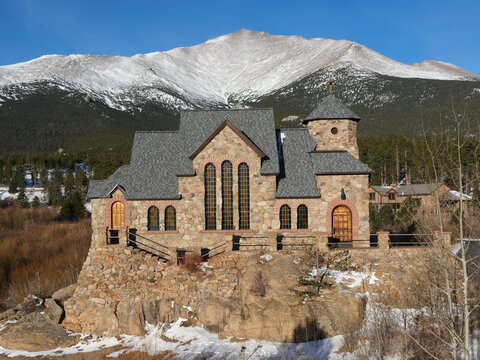 Saint Catherine&rsquo;s Chapel on the Rock with snowy Mount Meeker, Colorado winter landscape