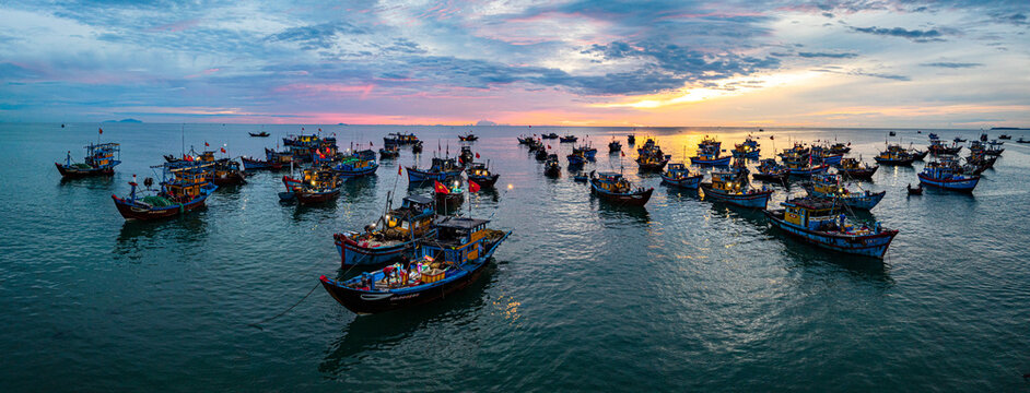 Fishing boats gather at sunrise in the waters of Tam Tien in Central Vietnam