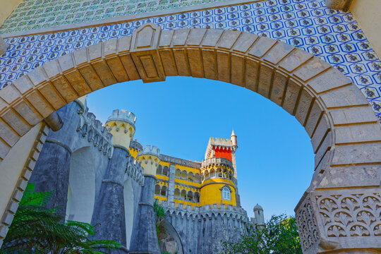 Exploring the unique architecture and colorful features of Pena Palace set against a clear blue sky