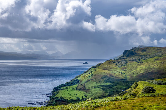 Coastline along Trotternish escarpment on Isle of Skye with hills and water in view