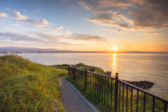 Sunrise over Cape Tachimachi with a pathway along the coast in Hakodate, Hokkaido, Japan