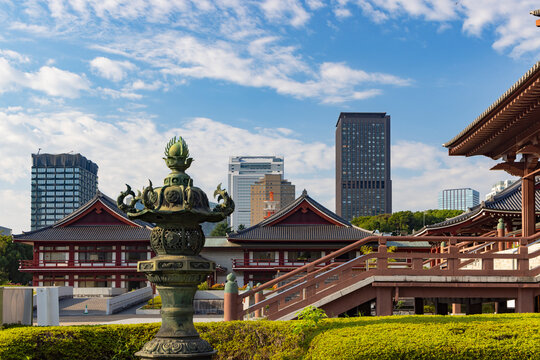 Exploring modern structures behind Zojo-ji Temple in Tokyo Japan with a focus on the traditional design and city skyline