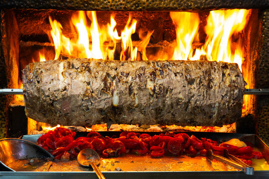 Cooking doner kebab over open flames in Paspatur market while preparing for customers in Fethiye, Mugla Province