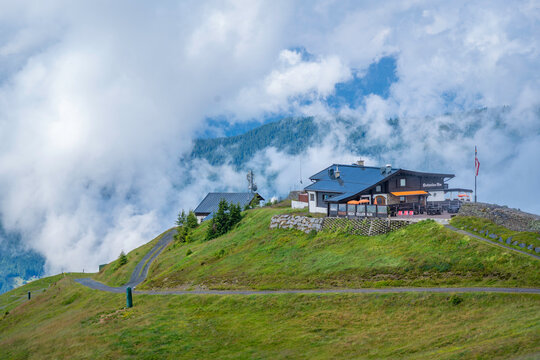 Clouds surround Hochzeller-Alm at 1959m with view from Schmittenhohebahn top station near Zell am See in Austria