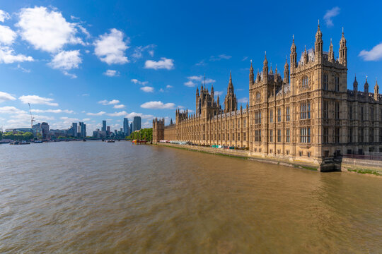 View of Houses of Parliament from Westminster Bridge on a summer day in London, England, with clear skies and city backdrop