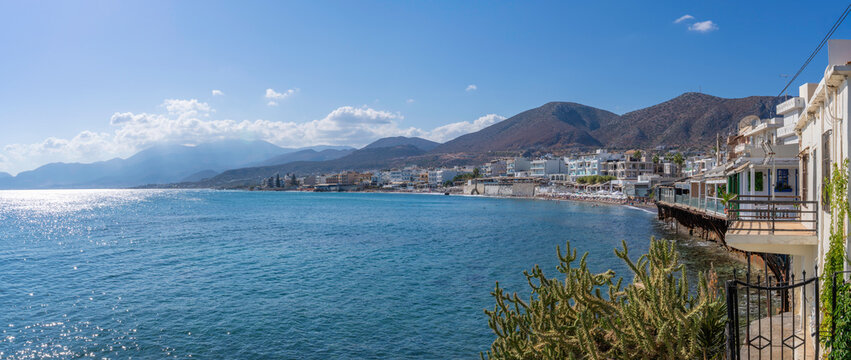 Coastline view of Paralia Limena Chersonisou Beach with clear waters and mountains in the background