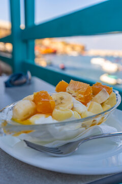 Traditional Greek yoghurt fruit salad served in Crete at a seaside location during the warm season