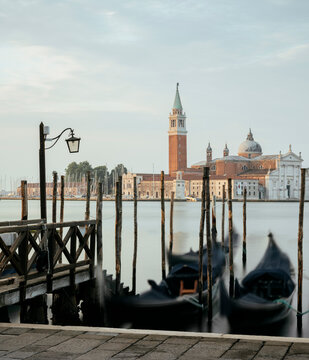 Goldolas on the lagoon at dawn with a view of San Giorgio Maggiore in the background near San Marco in Venice, Italy