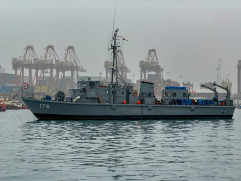 Scenes displaying naval presence at Callao Harbor in Peru with cargo cranes in the background
