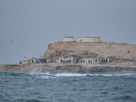 Fog and storms surround Palomino Islands near Lima, showing rugged coastlines and distant structures