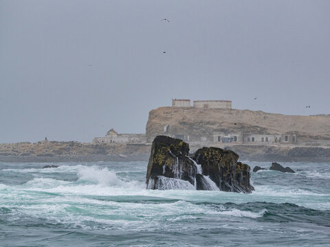 Scenes capture rough waters and rocks in Palomino Islands on a foggy stormy day near Lima Peru