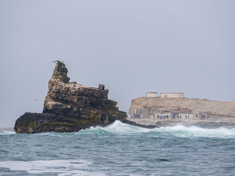 Foggy and stormy conditions at Palomino Islands near Lima, Peru, showing rocky formations and waves