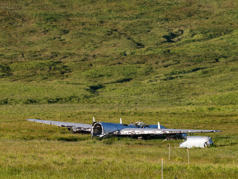 Wrecked B-24 Liberator bomber rests in field after running out of fuel in WWII at Bechevin Bay, Atka Island, Alaska
