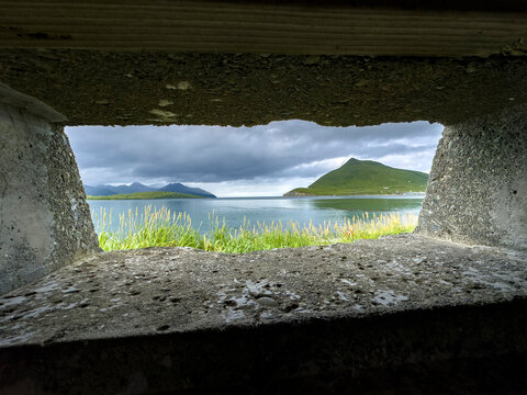 Remains of World War II bunkers in Dutch Harbor, seen from inside the structure looking out toward the water and land