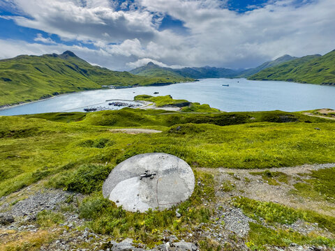 Remains of a World War II gun emplacement in a remote location near a body of water in Alaska
