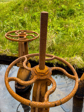 Rusty valves at the site of Sand Bay Naval Station on Great Sitkin Island, Alaska, showing remnants of World War II history