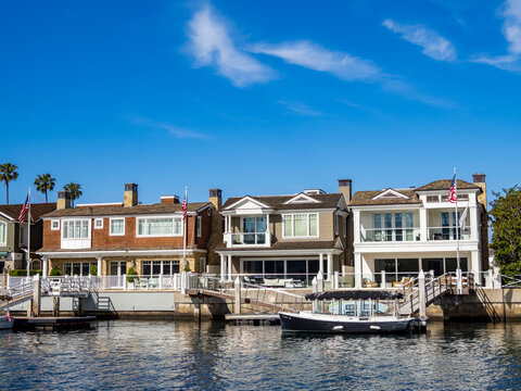 Luxury homes along the waterfront in Newport Beach attract visitors and residents in California