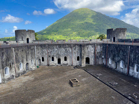 Fort Belgica stands in Banda Neira, showing its structure against the backdrop of a mountain in Indonesia