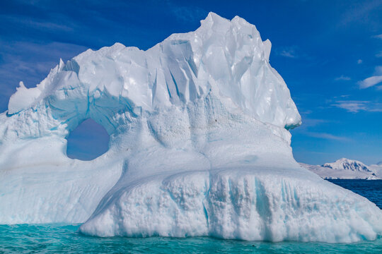 Detail of blue around an iceberg in Antarctica during summer months shows structure and formations