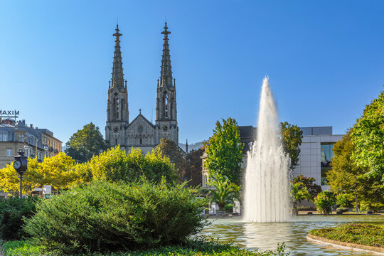 View of Augustaplatz Square with fountain and church in Baden-Baden during a sunny day in Baden-WĂĽrttemberg, Germany