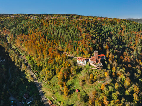 Liebenzell Castle sits on a hill surrounded by trees in the Black Forest region of Germany during autumn