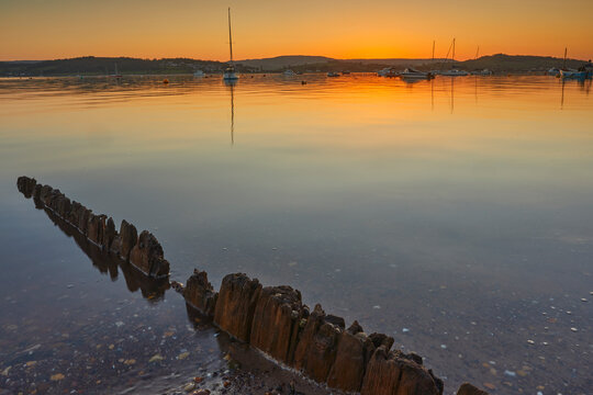 Dusk settles over the estuary of the River Exe at Exmouth with boats scattered across the water under a colorful sky