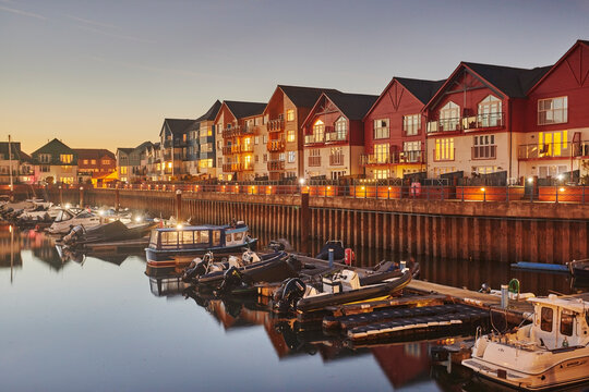 Dusk view of the harbour with boats and apartments in Exmouth, Devon, United Kingdom