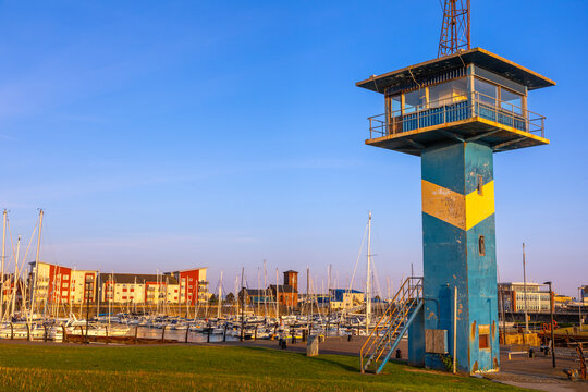 Harbour control tower stands beside boats at Ardrossan marina during sunset in North Ayrshire, United Kingdom