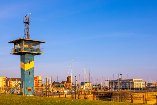 Harbour control tower overlooks marina and boats at Ardrossan in North Ayrshire, Scotland during the afternoon