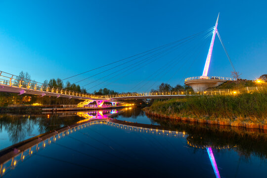 Stockingfield Bridge spans the Forth and Clyde Canal in Glasgow, showcasing modern architecture and evening lights in Scotland
