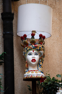 Unique lamp designed as a decorative head in historic old town Taormina, Sicily