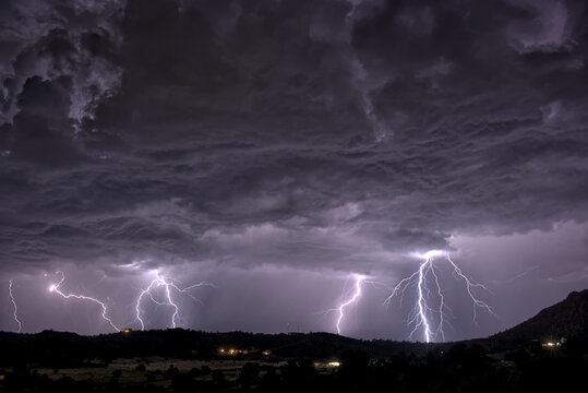 Multiple lightning strikes illuminate the night sky over Sullivan Butte in Chino Valley Arizona on August 14th 2025