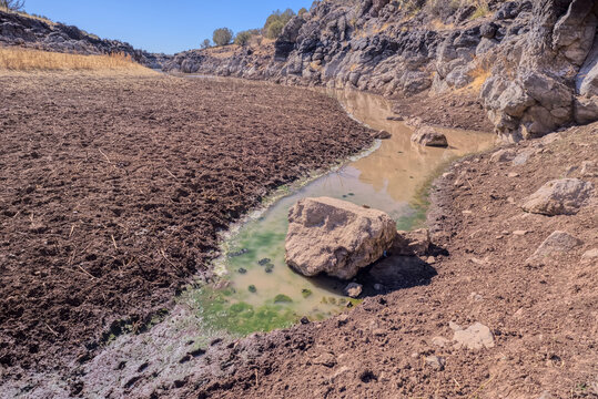 Historic Bainbridge Steel Dam lake edge shows low water levels in Kaibab National Forest near Ash Fork Arizona