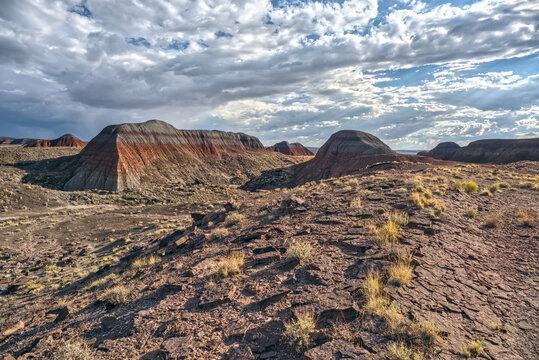 Northside view shows Teepees at Petrified Forest National Park in Arizona with clouds above and rocky terrain below