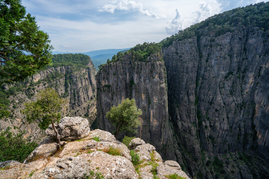 Impressive cliffs of Tazi Canyon are seen on a cloudy day in Turkey, showcasing nature's formations over time and their rugged landscape