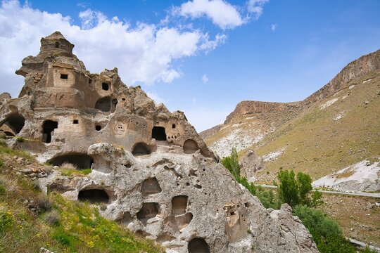 Exploring ancient rock houses with multiple floors in Cappadocia, Turkey during daylight