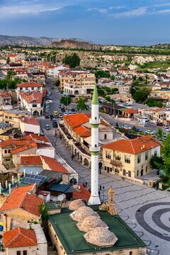 View of traditional houses and mosque in Ortahisar from castle in Cappadocia Turkey during sunny day