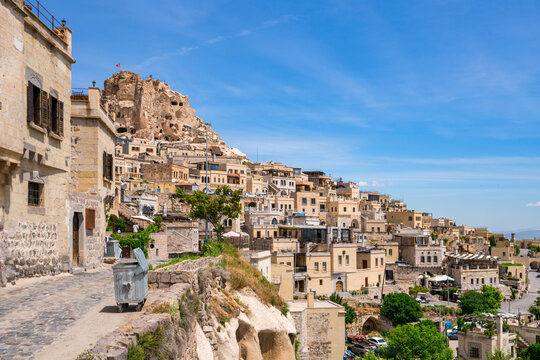 Explore Uchisar town with traditional houses under clear blue skies in Cappadocia, Turkey