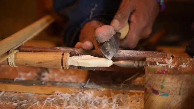 HD 1080p video at 60 fps of an artisan carving bone on his foot-operated hand lathe, a traditional Mexican craft style

