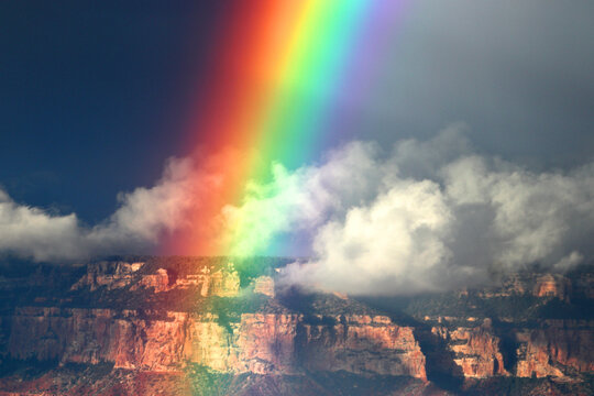 Rainbow appears above the Grand Canyon after rain in Arizona, USA showcasing natural beauty in the sky and rock formations
